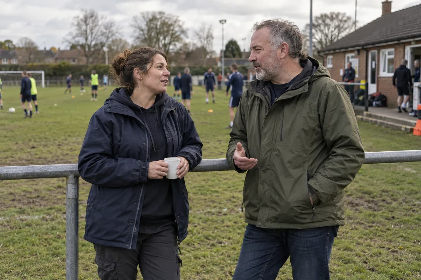 Club volunteers working together beside a community football pitch
