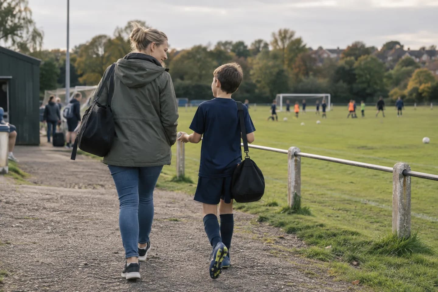 Parent and child at a local grassroots football pitch